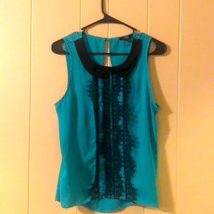 Retro, feminine blouse has delicate black lace detail. It’s incredibly flowy!